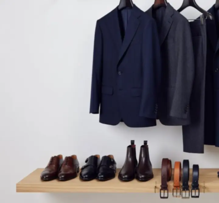 Curated men's wardrobe display featuring coordinated outfits and accessories